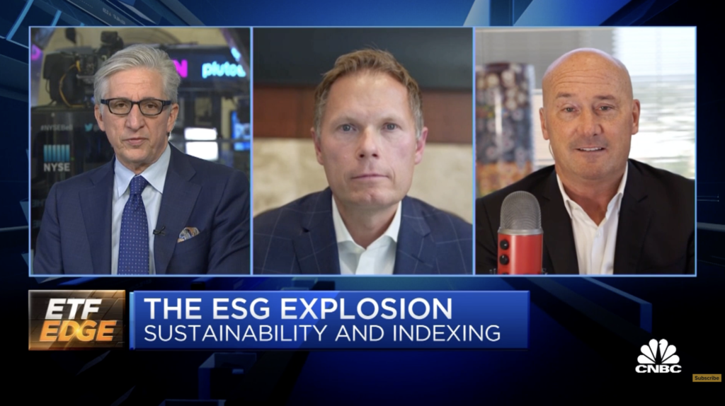 Three men in suits appear in a split-screen video call on CNBC’s ETF Edge. Text on screen reads: “THE ESG EXPLOSION, SUSTAINABILITY AND INDEXING.” One man holds a red microphone, as crypto trends and the stock exchange are discussed. | esgnews.com