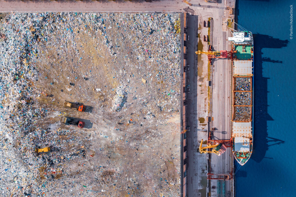 Waste loading at port cargo ship transports of garbage for recycling factory. Concept plastic Pollution environment, aerial top view